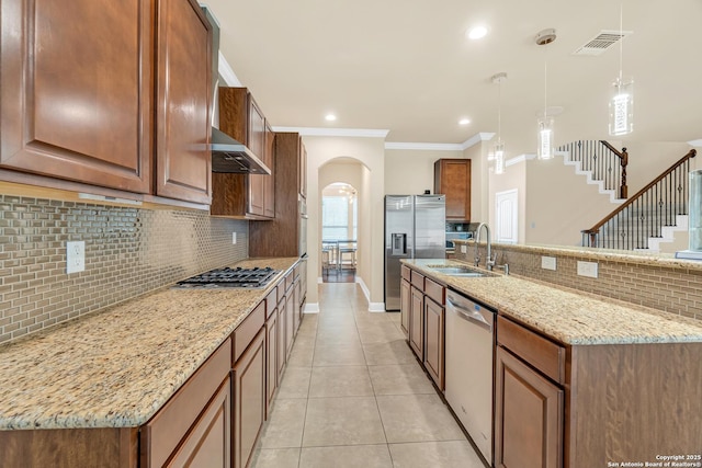 kitchen featuring decorative light fixtures, sink, light tile patterned floors, stainless steel appliances, and light stone countertops