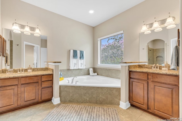 bathroom featuring tile patterned flooring, vanity, and shower with separate bathtub