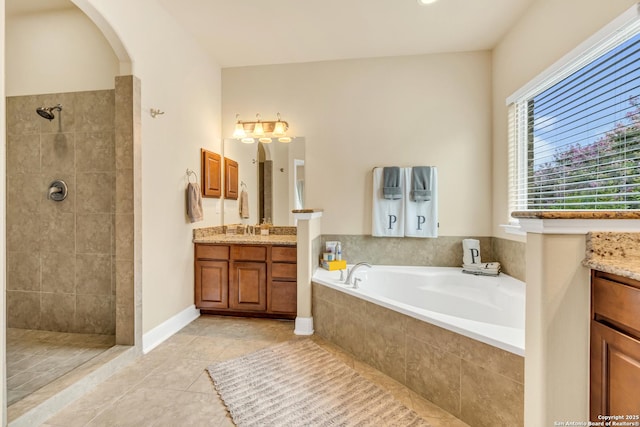 bathroom with vanity, tile patterned floors, and plus walk in shower