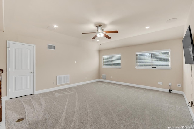 empty room with light colored carpet and ceiling fan