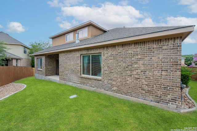 back of house with a lawn