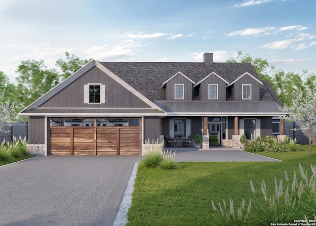 view of front facade featuring a garage, a front lawn, and covered porch