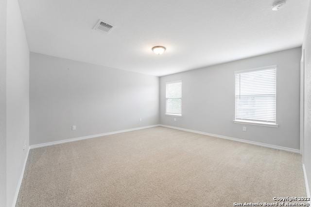 unfurnished room with light colored carpet