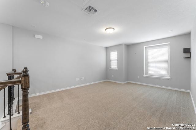 empty room featuring light colored carpet