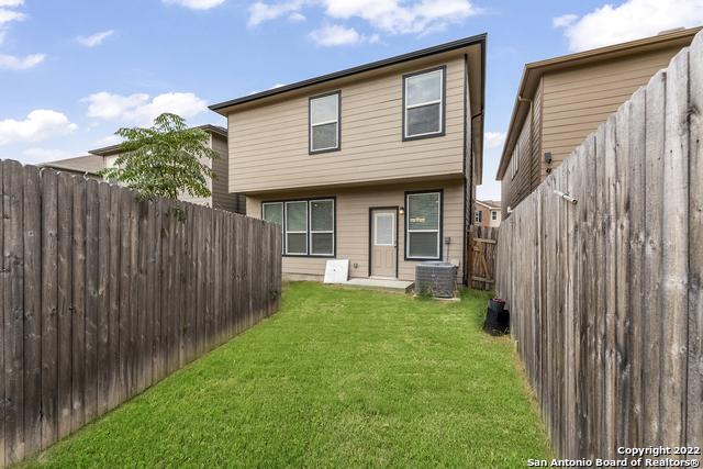 rear view of property featuring a yard