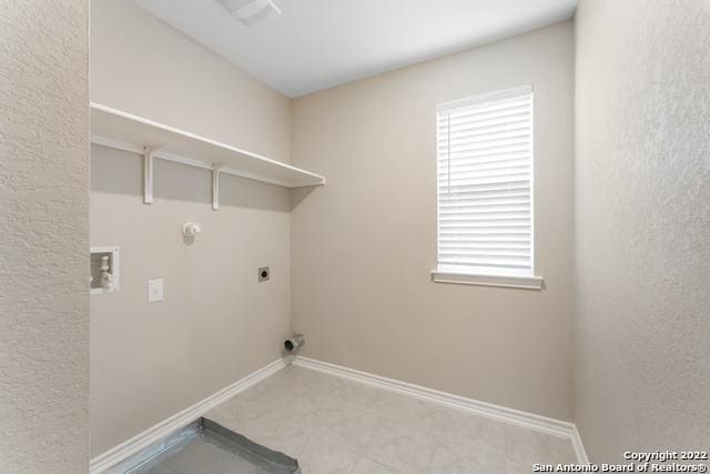 clothes washing area with hookup for a washing machine, hookup for a gas dryer, and hookup for an electric dryer