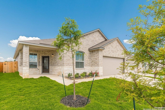 view of front of home featuring a garage and a front yard