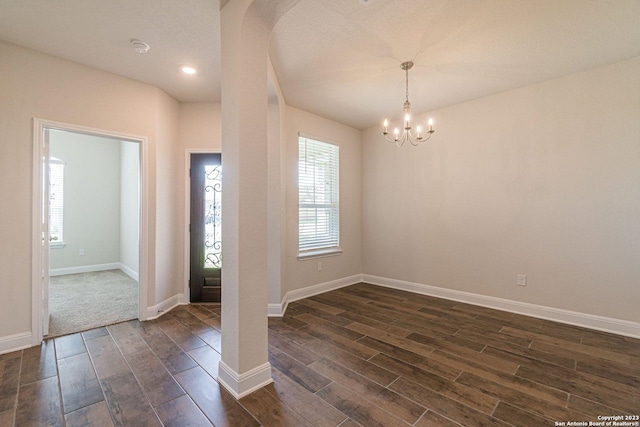 entrance foyer with dark wood-type flooring and a notable chandelier