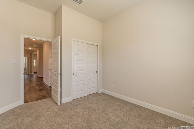 unfurnished bedroom featuring a closet and carpet flooring