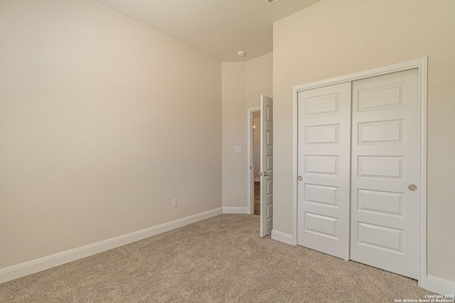 unfurnished bedroom with carpet and a closet