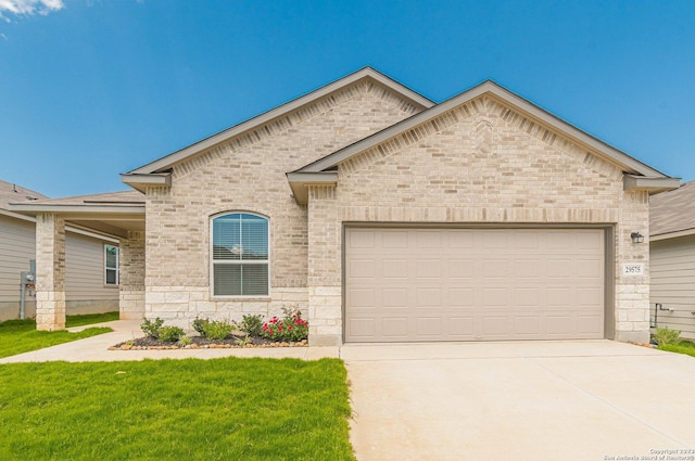 view of front of property featuring a garage and a front lawn