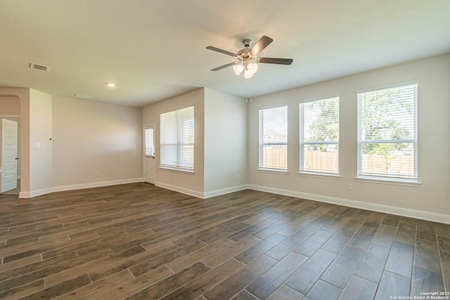 unfurnished room with dark wood-type flooring and ceiling fan