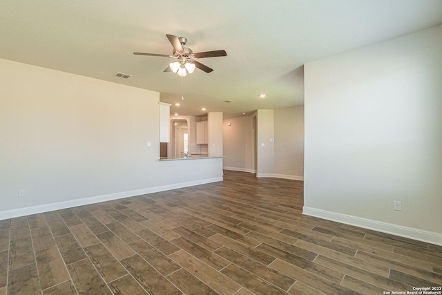 unfurnished living room featuring dark hardwood / wood-style floors and ceiling fan