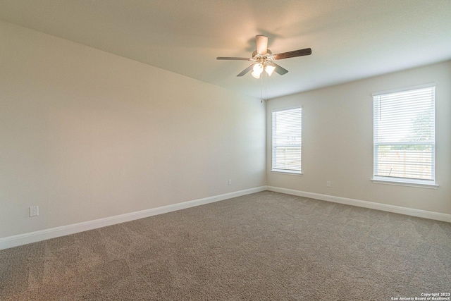 carpeted empty room featuring ceiling fan