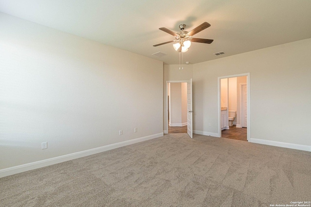 unfurnished bedroom featuring ceiling fan, carpet, and ensuite bath