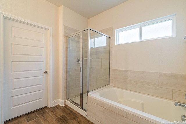 bathroom with hardwood / wood-style flooring and plus walk in shower