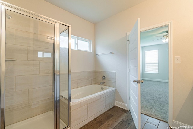 bathroom with hardwood / wood-style flooring, a wealth of natural light, and shower with separate bathtub