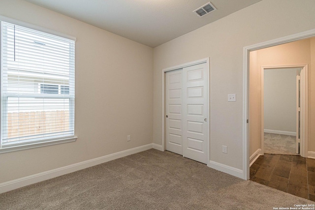 unfurnished bedroom featuring carpet floors and a closet