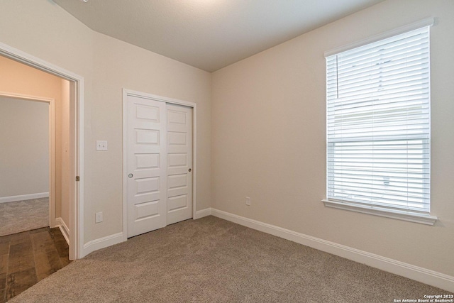 unfurnished bedroom with carpet and a closet