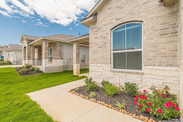 doorway to property with a lawn