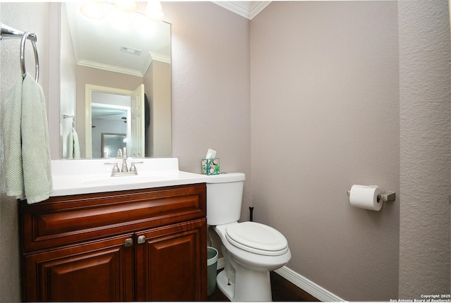 bathroom with ornamental molding, toilet, and vanity