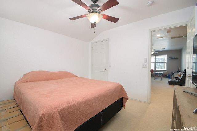 bedroom featuring light carpet, vaulted ceiling, and ceiling fan