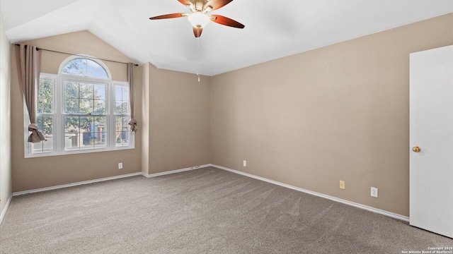 spare room featuring lofted ceiling, ceiling fan, and carpet