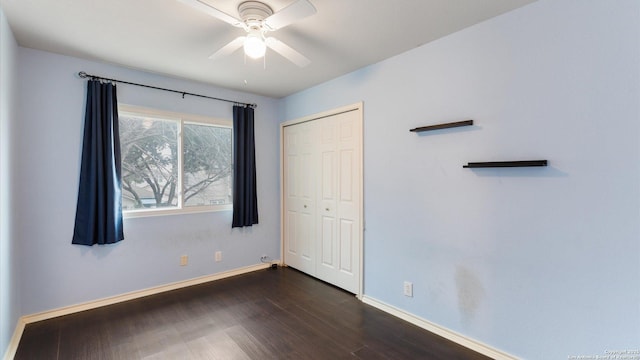 unfurnished bedroom with ceiling fan, dark hardwood / wood-style flooring, and a closet