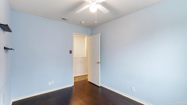 unfurnished room with dark hardwood / wood-style floors and ceiling fan