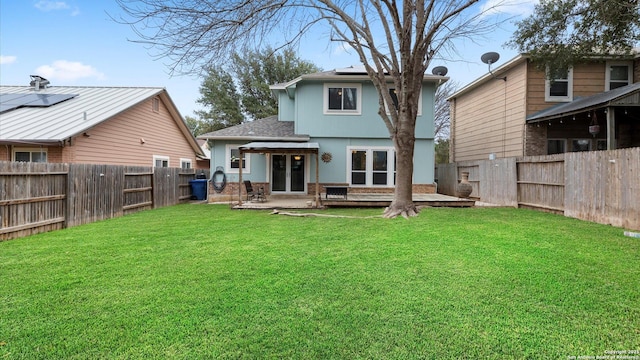 back of house with a patio area and a lawn