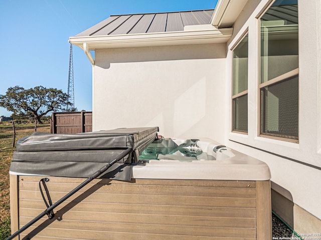 wooden deck featuring a hot tub