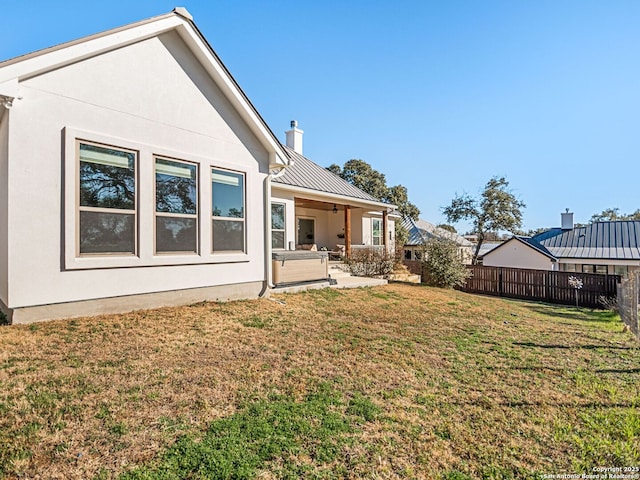 back of house featuring a yard and a patio area