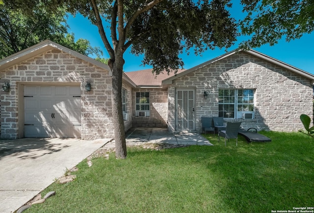 ranch-style house featuring a garage and a front yard