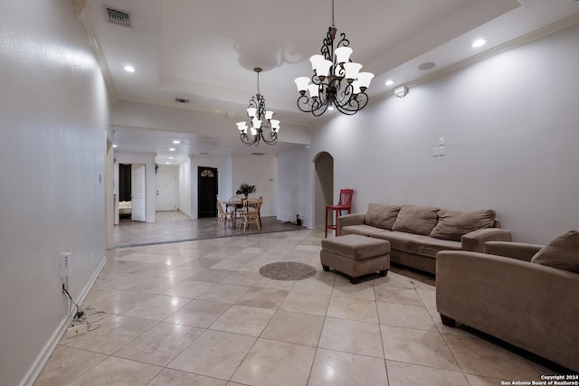 unfurnished living room with light tile patterned floors, a tray ceiling, ornamental molding, and a notable chandelier