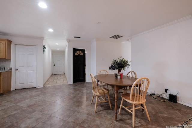 tiled dining room with ornamental molding