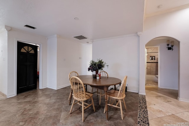 tiled dining room with ornamental molding