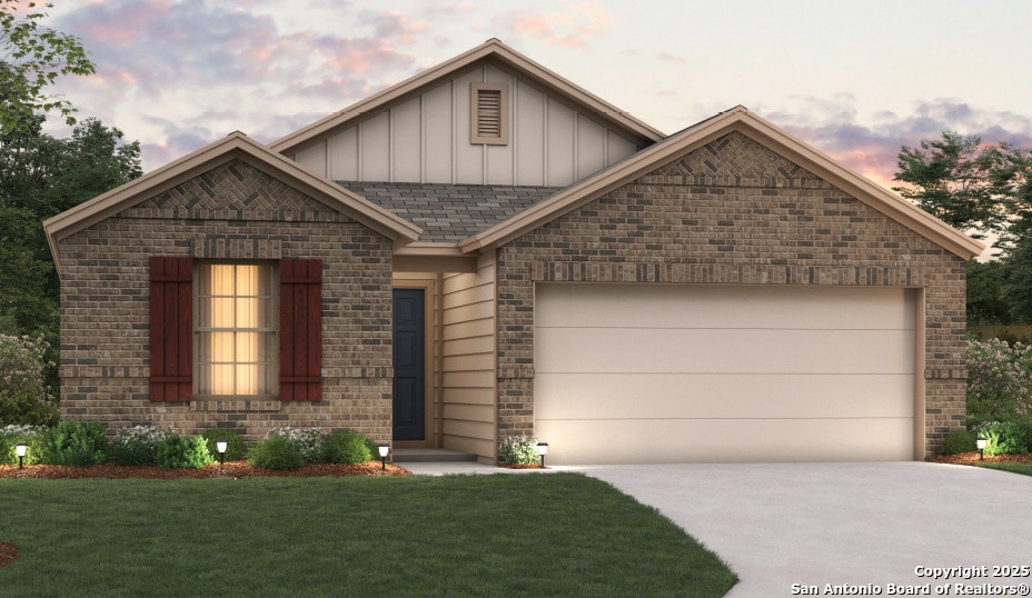 view of front of house with a garage and a lawn