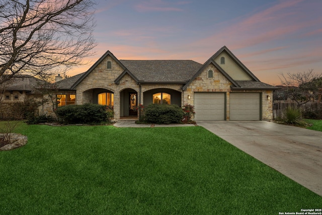 view of front of home featuring a yard and a garage