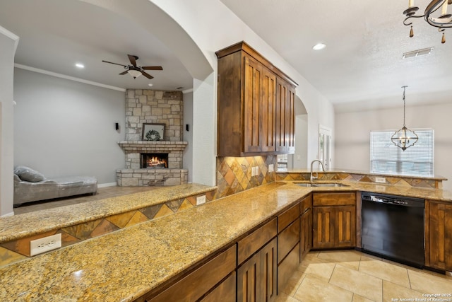 kitchen featuring pendant lighting, black dishwasher, sink, backsplash, and kitchen peninsula