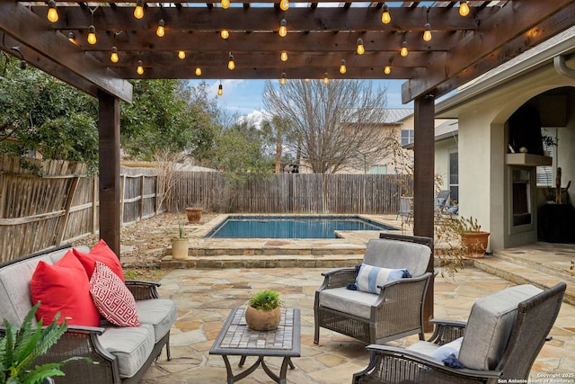 view of patio featuring a fenced in pool, outdoor lounge area, and a pergola