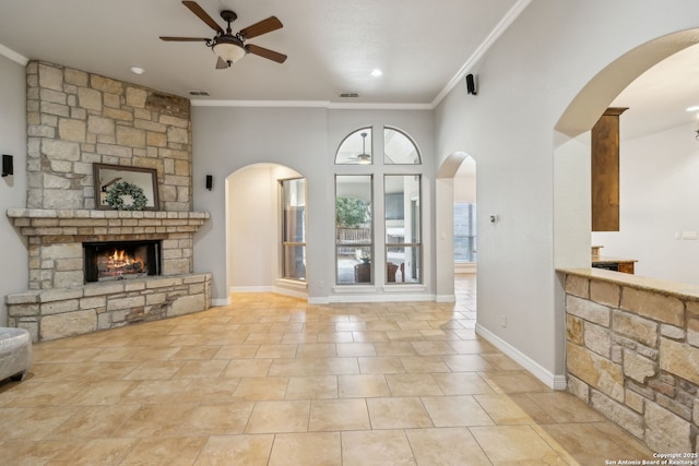 living room featuring ornamental molding, light tile patterned floors, ceiling fan, and a fireplace