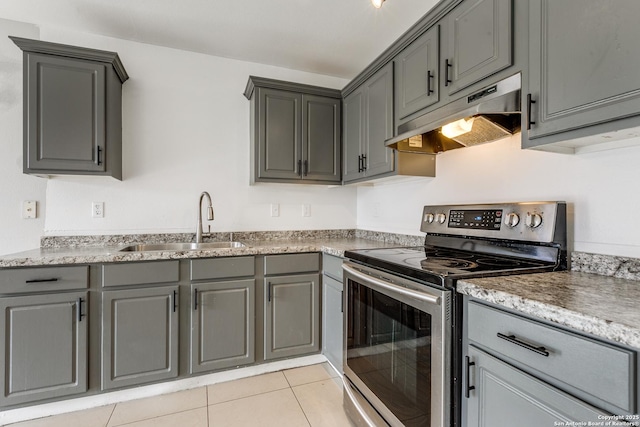 kitchen with gray cabinetry, sink, electric range, and light tile patterned flooring