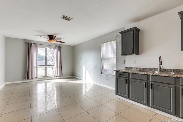 kitchen with sink, ceiling fan, and light tile patterned flooring