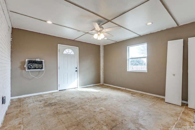 entryway with brick wall, heating unit, and ceiling fan