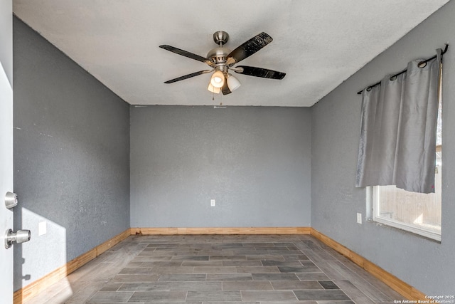 unfurnished room with ceiling fan