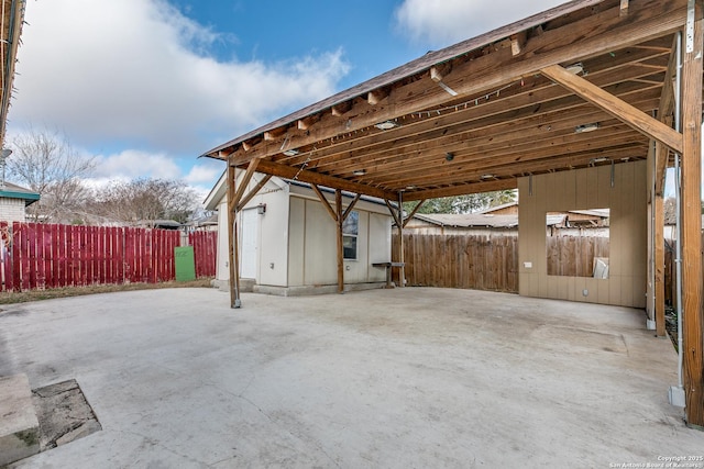 view of patio featuring a carport and an outdoor structure