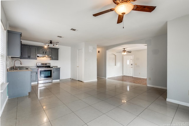 kitchen featuring light tile patterned floors, stainless steel electric stove, sink, and gray cabinets