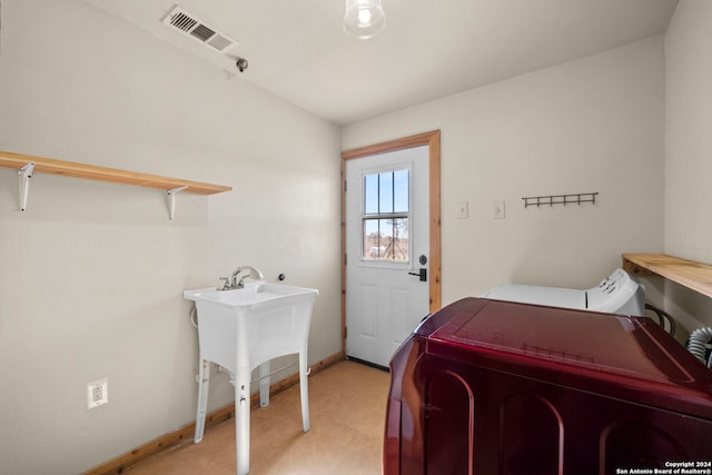 clothes washing area featuring washer and dryer