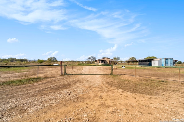 view of yard with a rural view and an outbuilding