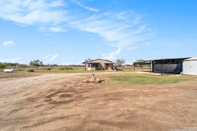 view of yard featuring an outbuilding and a rural view